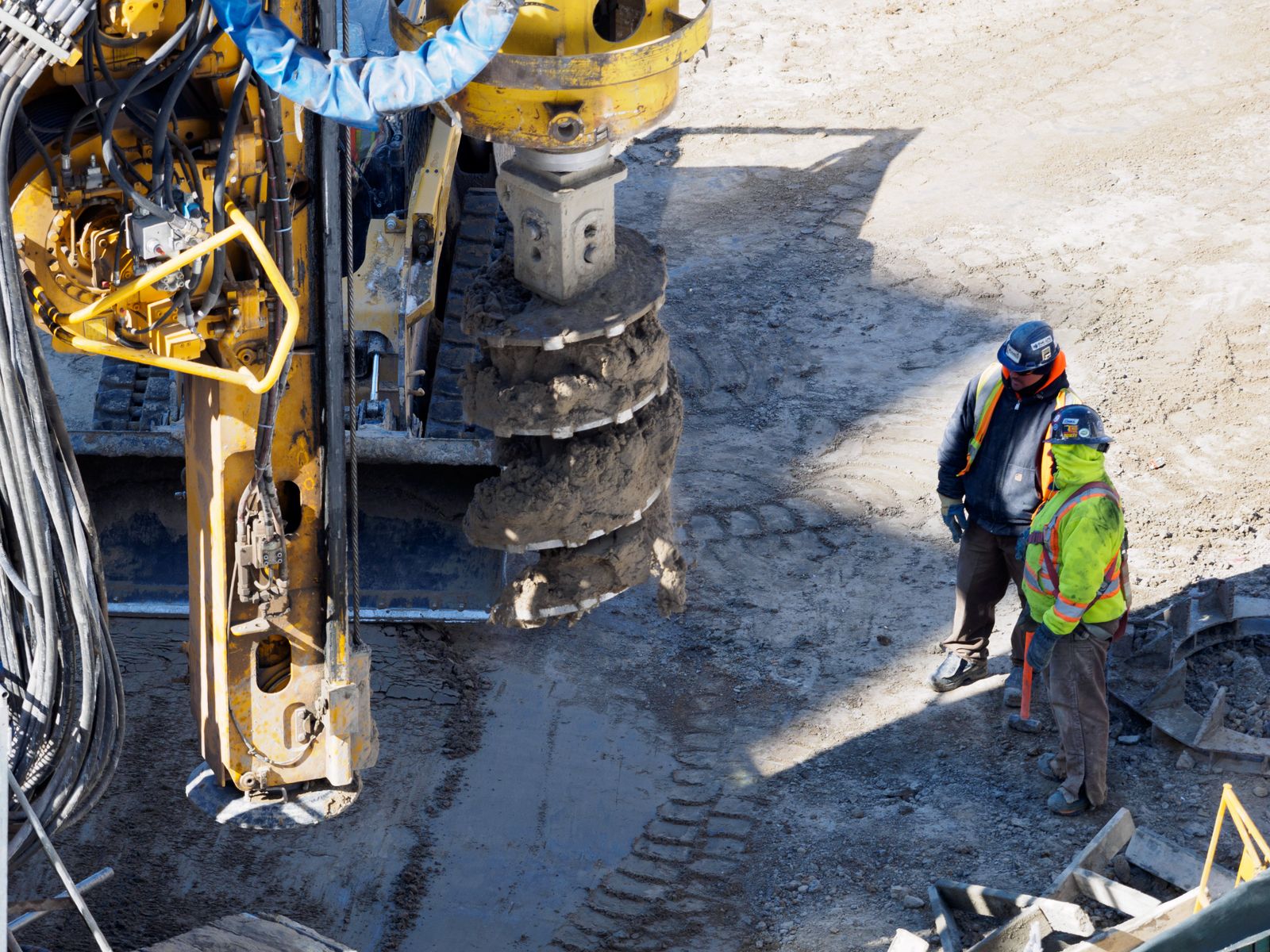 Well drilling crew and rig on a residential job site